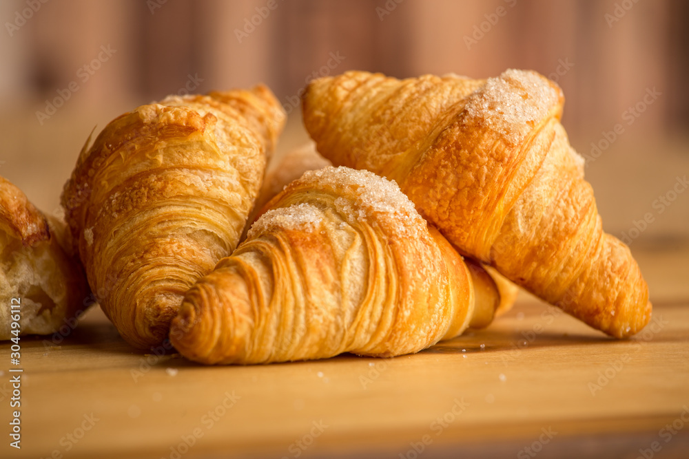  three croissants on a wooden board