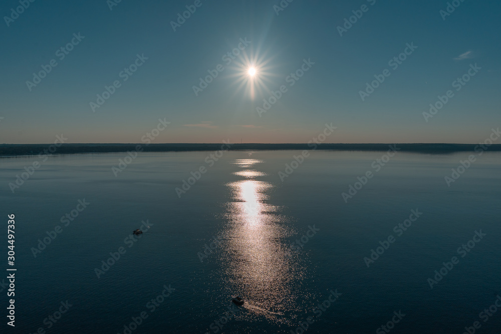 Sun in the sky over an open lake Sun in the sky over an open lake