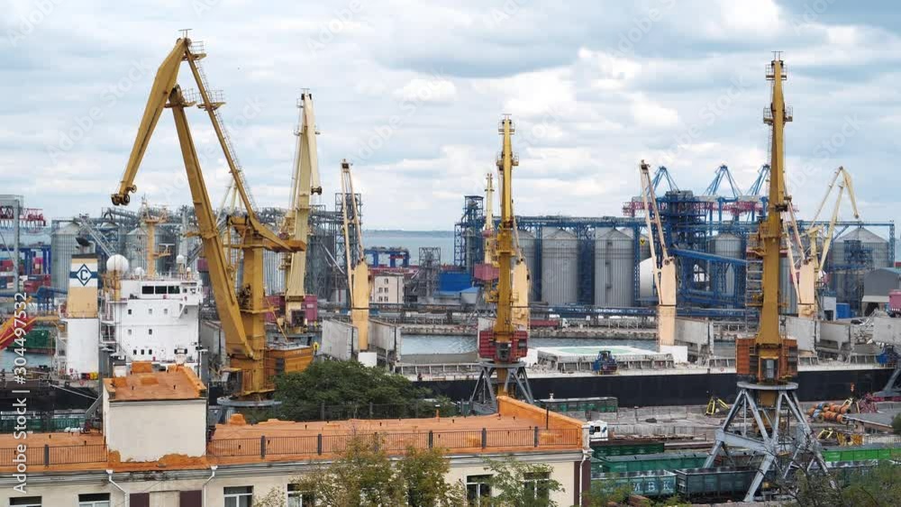 Working cranes in Odessa seaport, largest Ukrainian seaport and one of largest ports in Black Sea basin Working cranes in Odessa seaport, largest Ukrainian seaport and one of largest ports in Black Sea basin