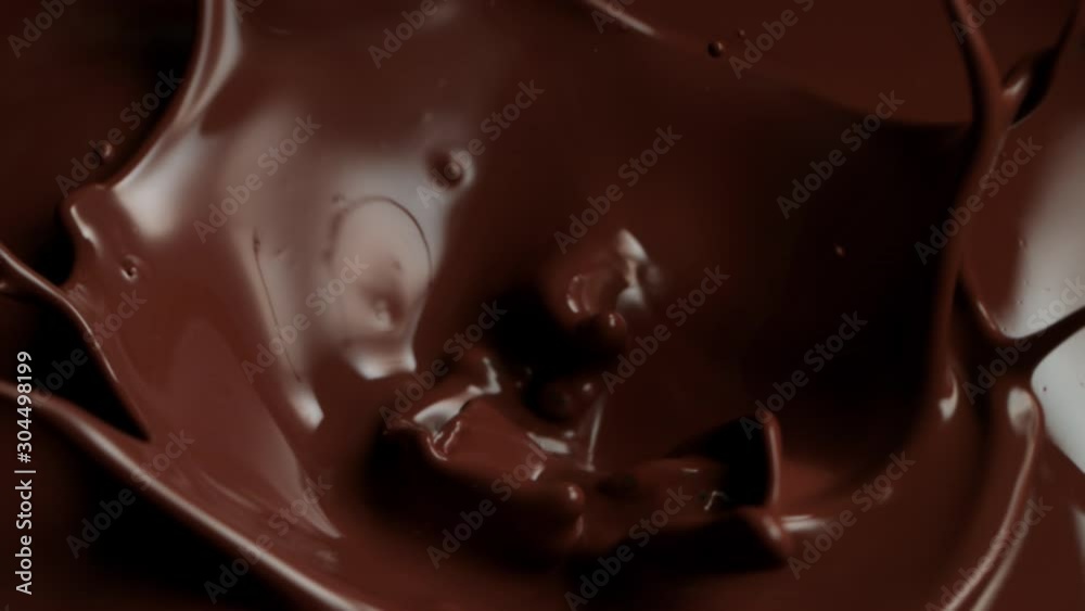 Super Slow Motion Shot of Raw Chocolate Chunks Falling into Melted Chocolate at 1000fps. Super Slow Motion Shot of Raw Chocolate Chunks Falling into Melted Chocolate at 1000fps.