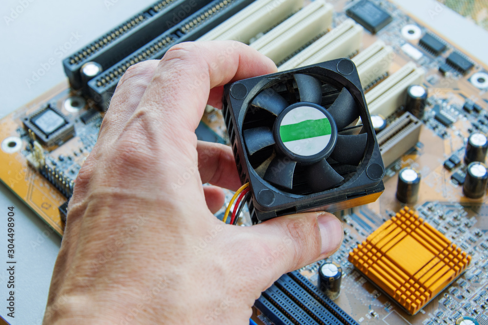 Technician install CPU cooler on modern PC computer motherboard. The  process of upgrading computer maintenance in a service. Stock Photo | Adobe  Stock