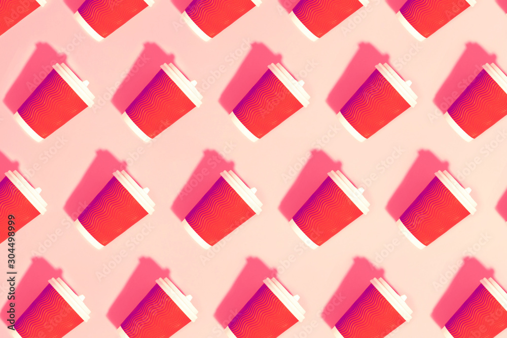 Pattern of many red paper coffee cups with white plastic covers laid in a row on pink backround. Flat lay. Morning, new day and ecology concept. Pop art style. Pattern of many red paper coffee cups with white plastic covers laid in a row on pink backround. Flat lay. Morning, new day and ecology concept. Pop art style.