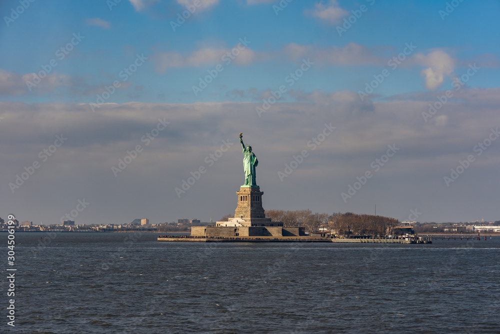 statue of liberty from the staten island ferry during a sunny day in winter statue of liberty from the staten island ferry during a sunny day in winter