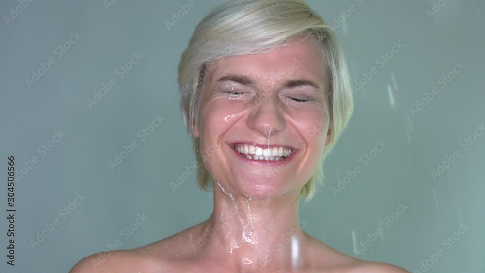 closed eyes blonde woman splashed with water, still medium close up shot closed eyes blonde woman splashed with water, still medium close up shot
