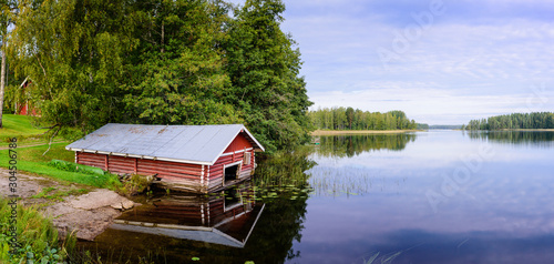 Picturesque lake with forest on the shore in Aurantola village. Typical nature of Finland.