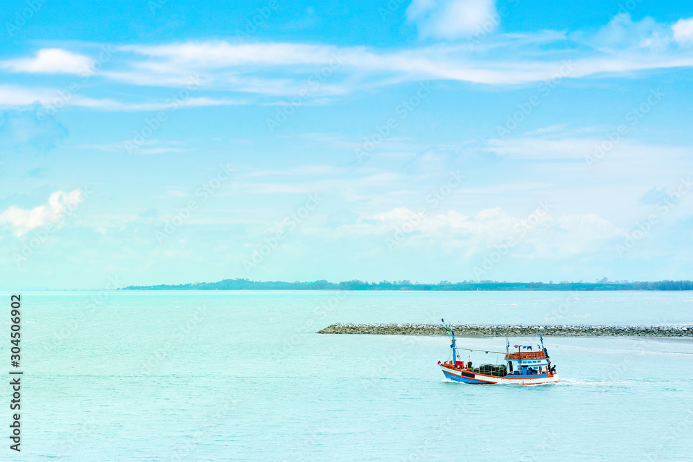 Beautiful seascape view nature with fishing boat and clear water sea blue sky clouds background in tropical ocean sea summer season Thailand.