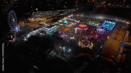 Aerial view of amusement luna park Shot Night City Lightst. big Ferris wheel bright illumination photo