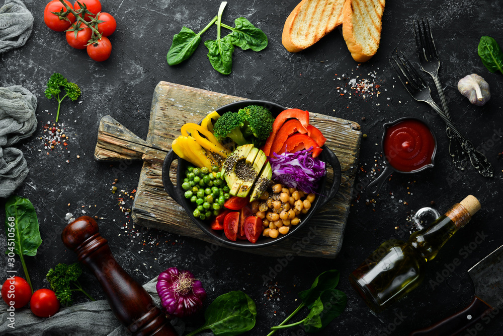 Buddha bowl: chickpeas, avocados, broccoli, paprika, green peas, tomatoes. Vegetable salad. Top view. Free space for your text. Buddha bowl: chickpeas, avocados, broccoli, paprika, green peas, tomatoes. Vegetable salad. Top view. Free space for your text.