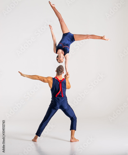 Konstfotografi Duo Of Acrobats Showing hand to hand Trick, Isolated On White