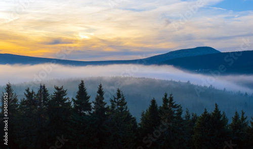 sunset mountain sky blue colorful autumn sun light yellow orange clouds tree smoke fog haze