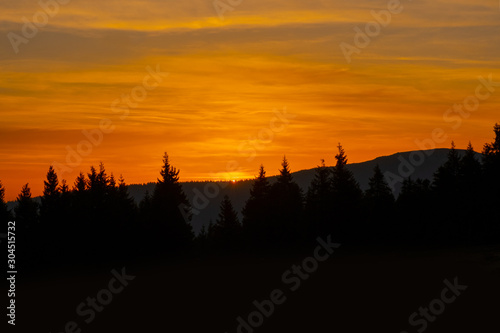 sunset mountain sky blue colorful autumn sun light yellow orange clouds tree smoke fog haze