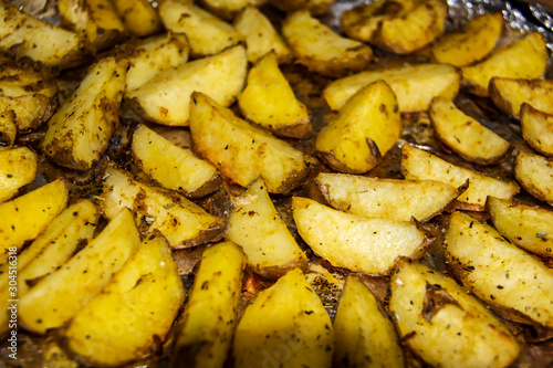 Fried potatoes in the oven.Cooking baked potato. Potatoes peasant. Potatoes with spices. Potatoes on the foil.