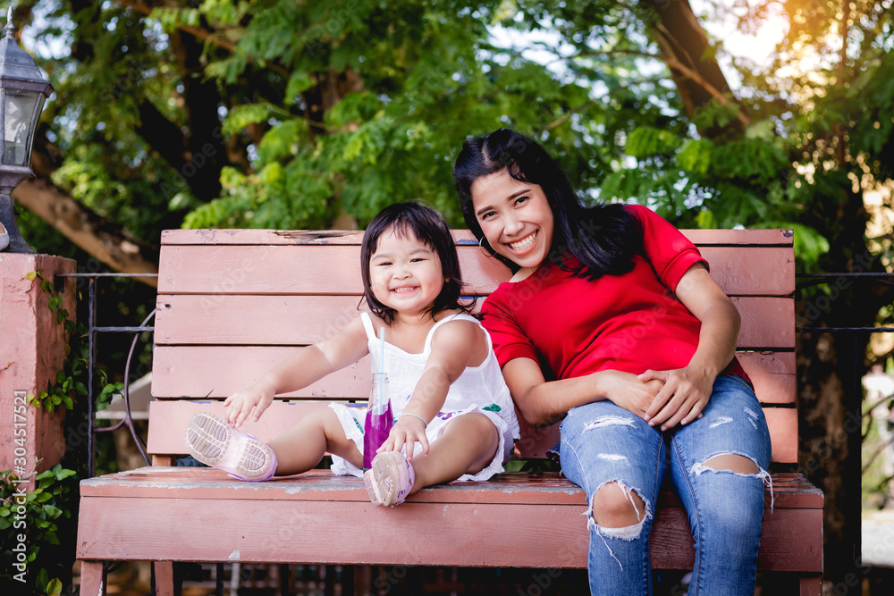 young couple sitting on a bench in the park young couple sitting on a bench in the park