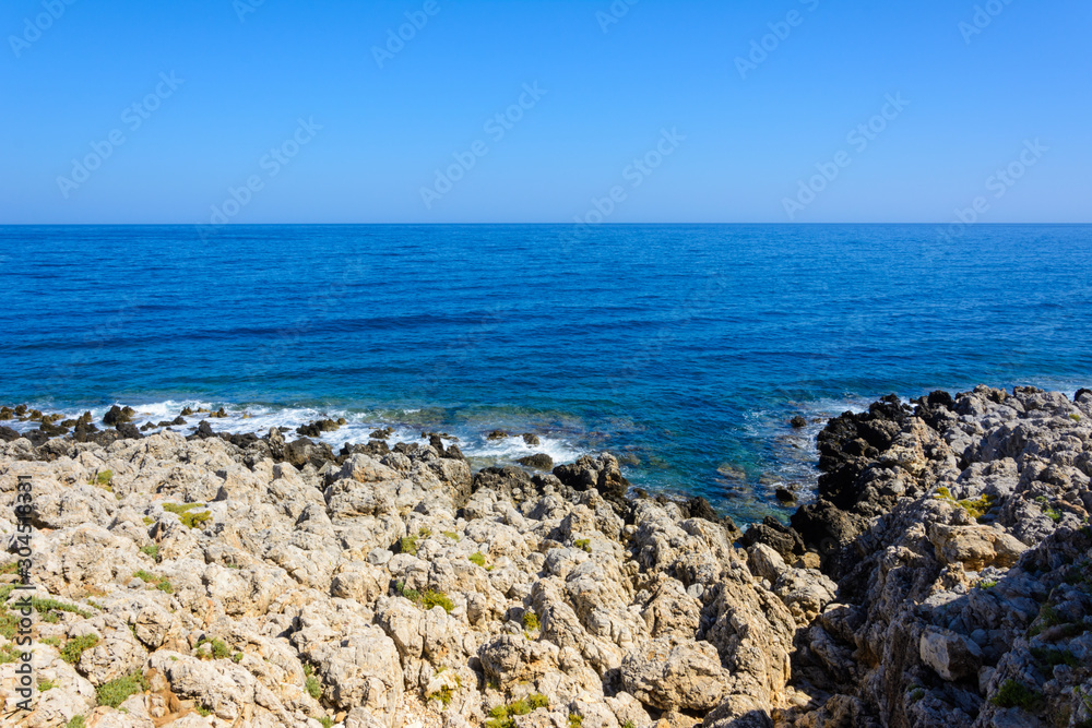 calm Mediterranean sea with clear horizon. stone Bank with rare grass. calm Mediterranean sea with clear horizon. stone Bank with rare grass.