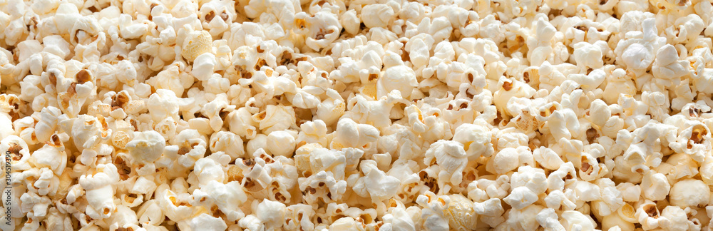 Popcorn background and texture. Panorama. Side view. Banner.