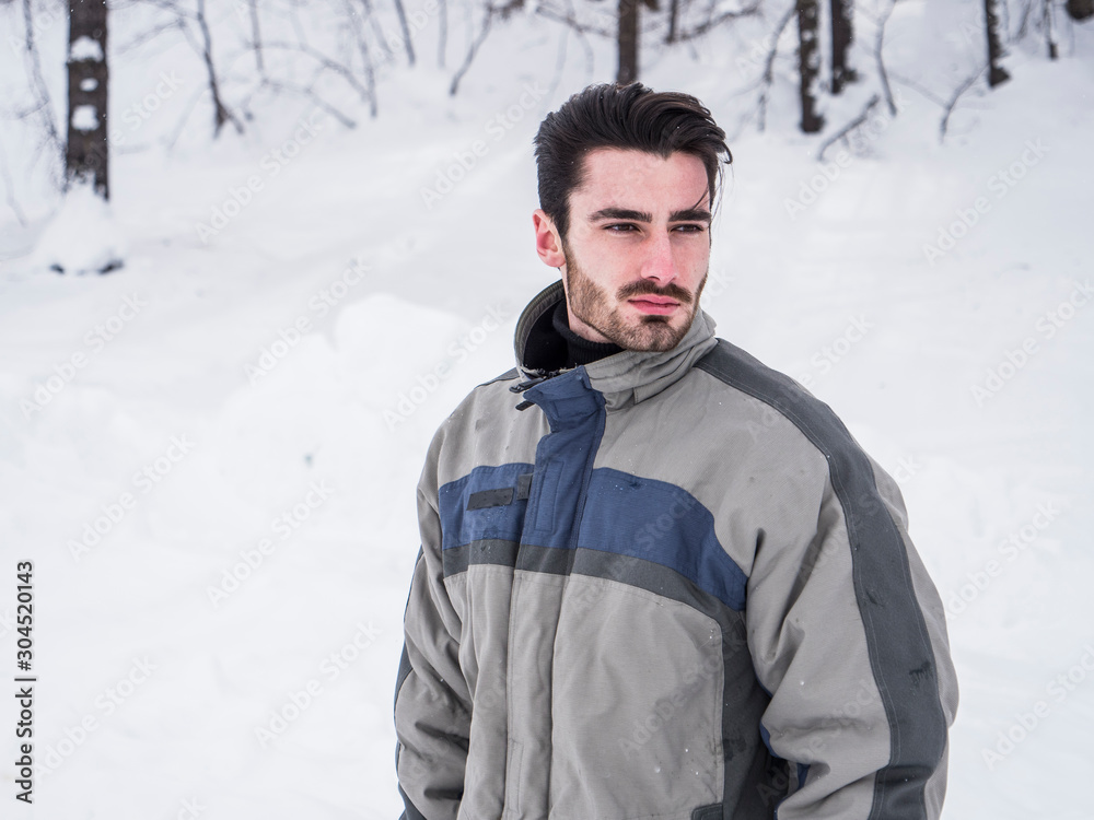 Young handsome man in winter sportswear looking away Young handsome man in winter sportswear looking away