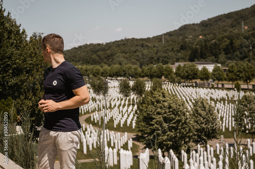 Srebrenica, 7. April 2017. Srebrenica–Potočari Memorial and Cemetery for the Victims of the 1995 Genocide. Bosnian men were executed by the Bosnian Serb Army. Man wearing Srebrenica flower. photo