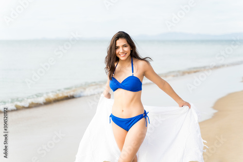 Young Woman Having Fun With Scarf On Beach