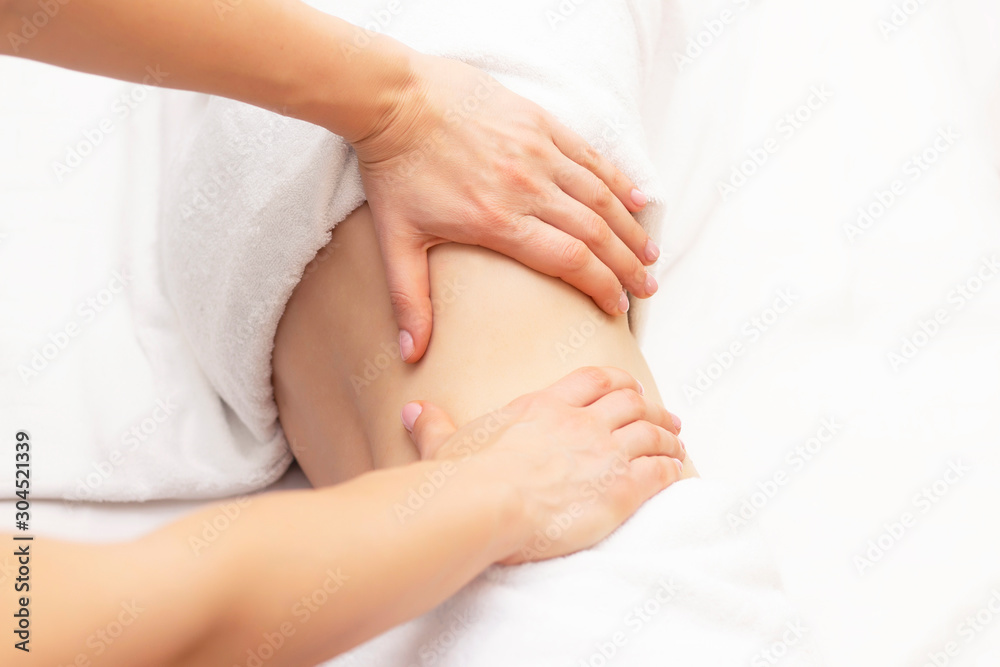 Massage Therapist Massaging a Womens Stomach. Massage and body care. Spa body massage woman hands treatment. Massage Therapist Massaging a Womens Stomach. Massage and body care. Spa body massage woman hands treatment.