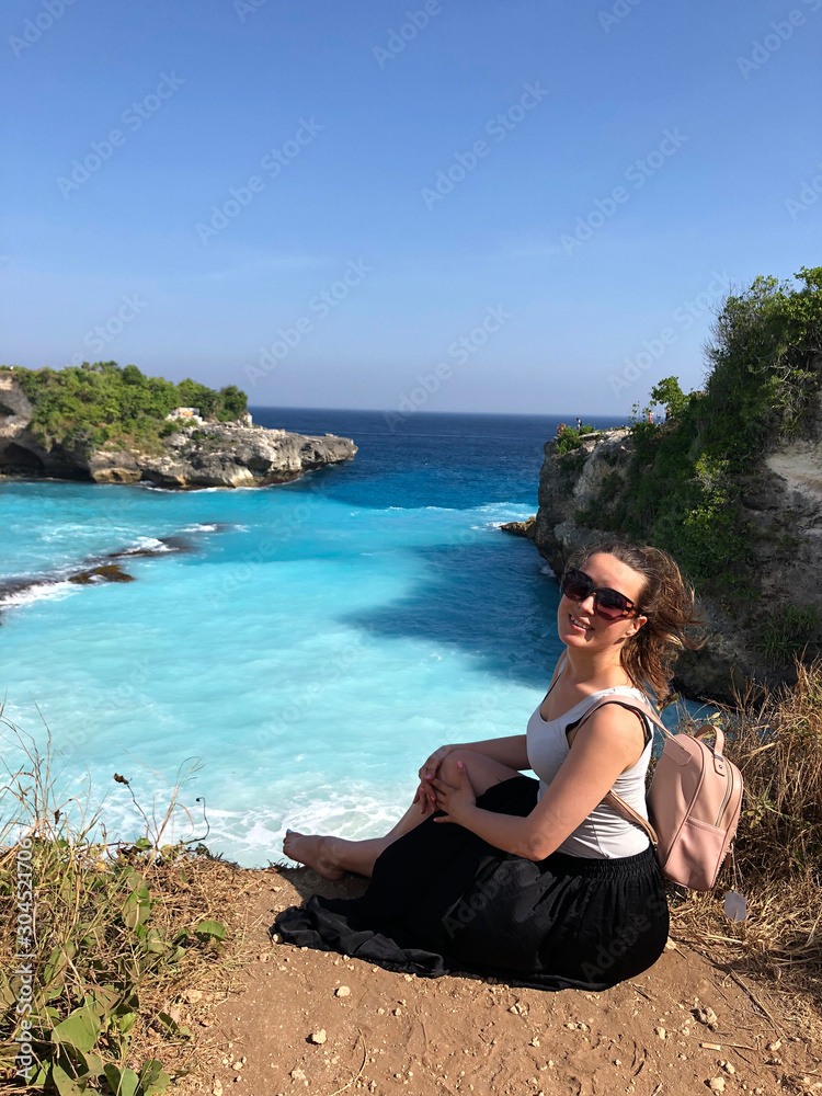 woman looks on View of the Blue Lagoon in Nusa Ceningan. turquoise lagoon beach near lembongan island