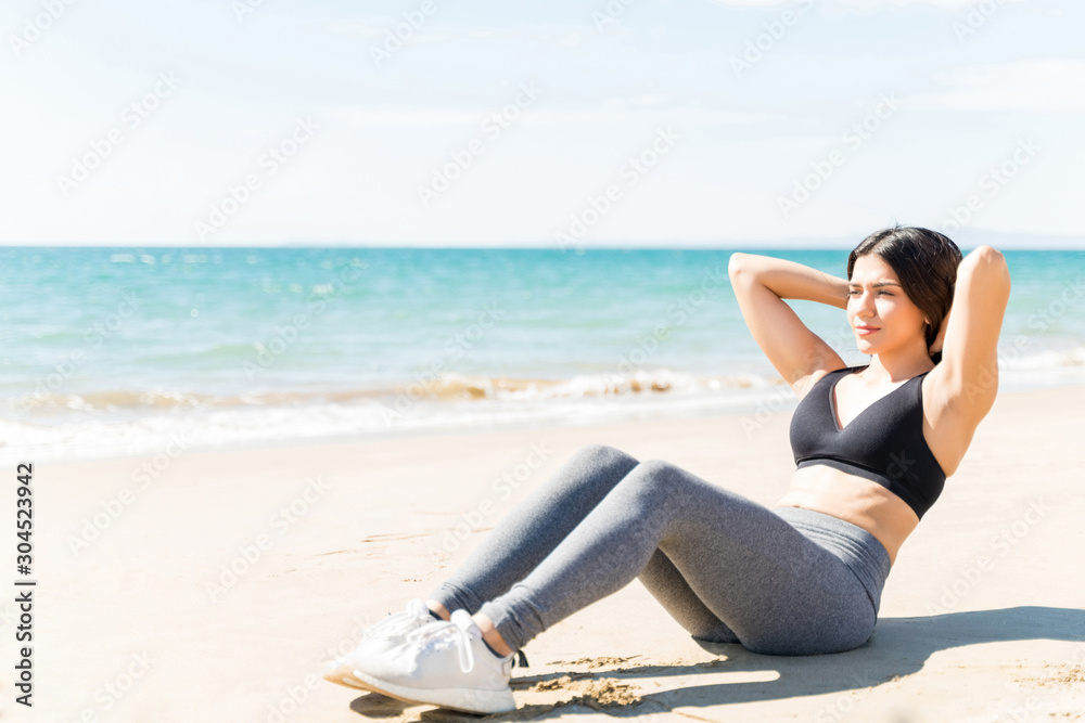 Woman Doing Exercises On Beach
