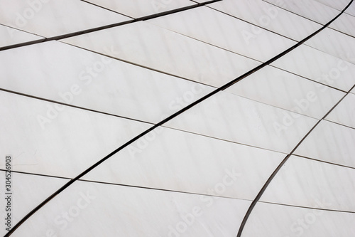 Gray concrete wall background. Curved lines, concrete slabs, the part of a modern building.