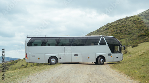 White BUS on the road in Geogrian Mountains
