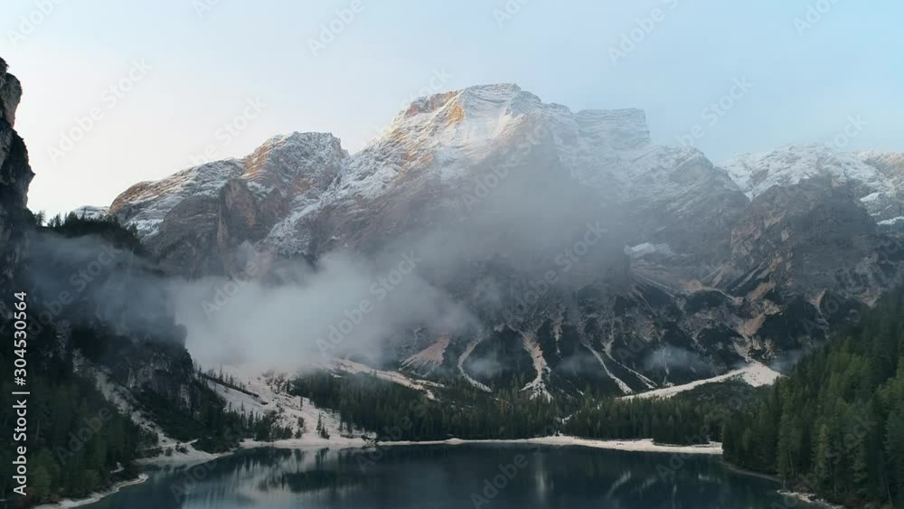 Snow mountain and cloudy lake aerial view 4k footage in Dolomites Italy Snow mountain and cloudy lake aerial view 4k footage in Dolomites Italy