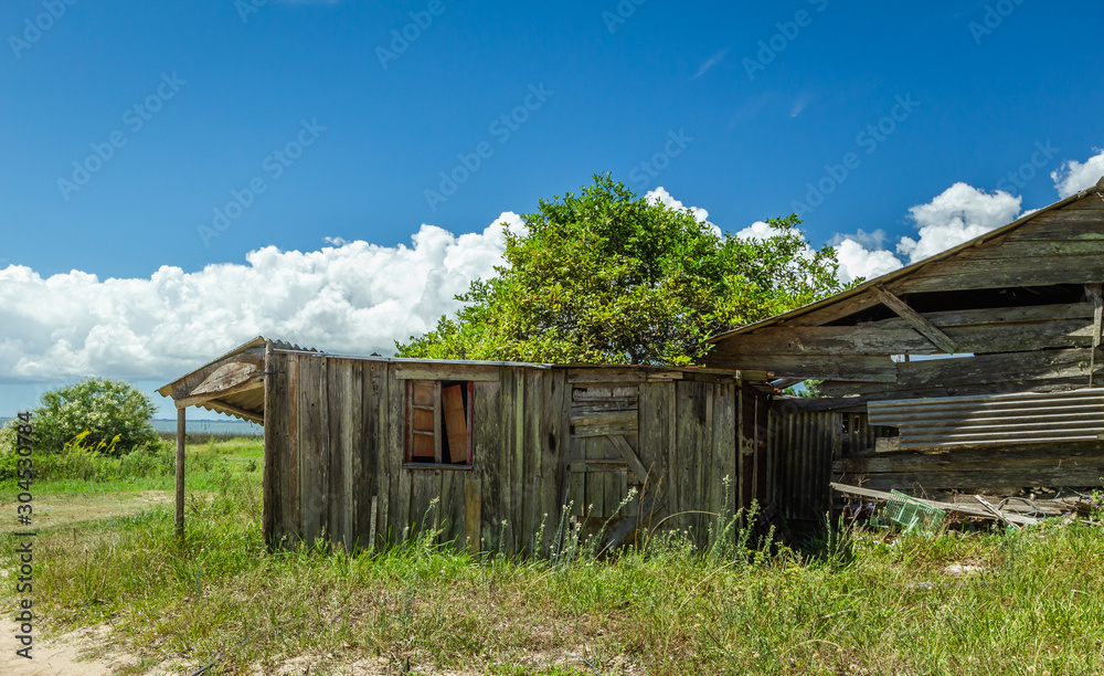 Modest wooden house owned by residents of Barranco Beach, located in the city of São José do Norte, in southern Brazil. Modest wooden house owned by residents of Barranco Beach, located in the city of São José do Norte, in southern Brazil.