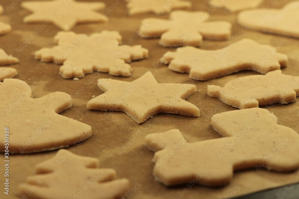 Raw gingerbread dough before go into oven. Baking together with mum and dad for good moments. Christmas cookies for Santa Claus or Baby Jesus. Concept of family, winter holidays Raw gingerbread dough before go into oven. Baking together with mum and dad for good moments. Christmas cookies for Santa Claus or Baby Jesus. Concept of family, winter holidays