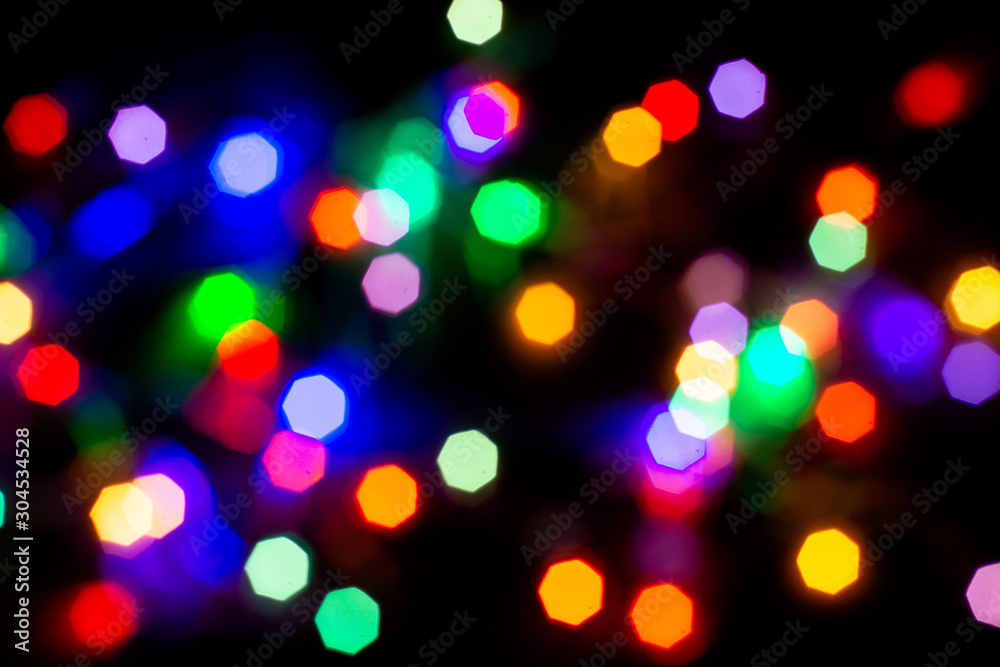 Christmas lights are lit on a black background. Copy the area for the top view text. Christmas lights are lit on a black background. Copy the area for the top view text.