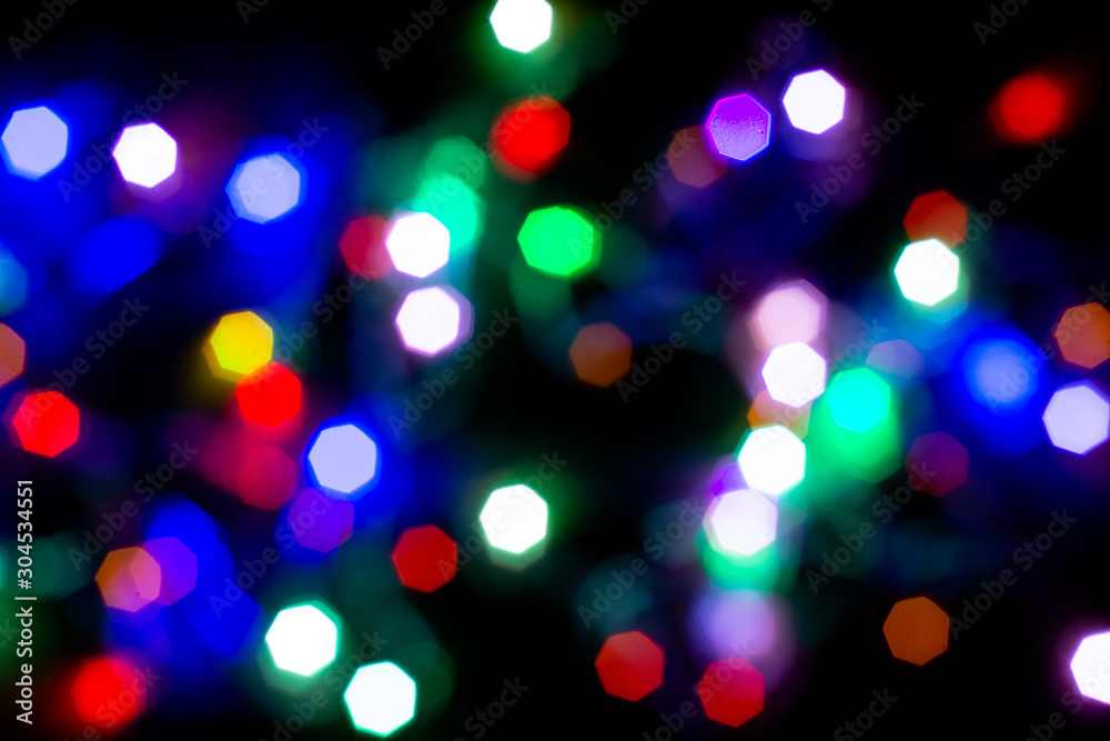 Christmas lights are lit on a black background. Copy the area for the top view text. Christmas lights are lit on a black background. Copy the area for the top view text.