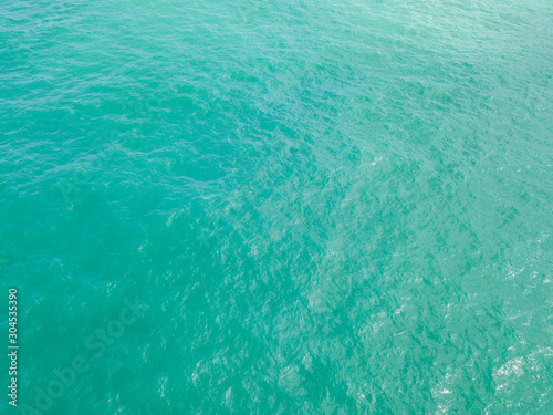 Aerial view of turquoise waves, water surface texture. Thailand