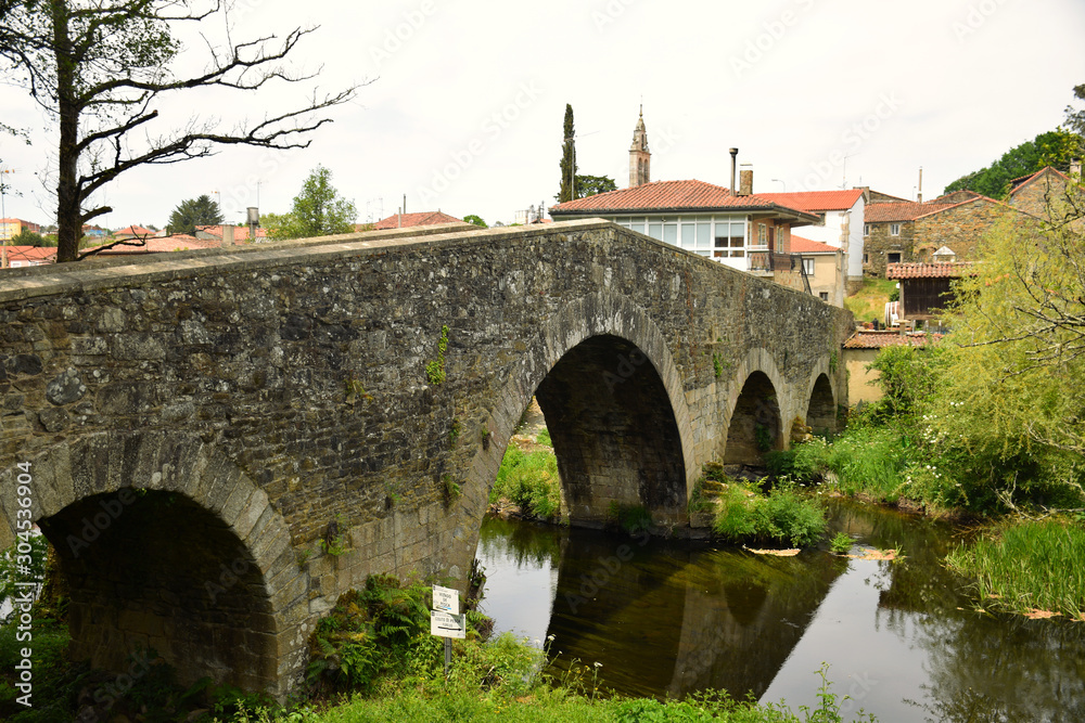Ancient medieval stone bridge on the Camino de Santiago, the Compostela pilgrimage thru-hike, Galicia, Northern Spain (Spring)