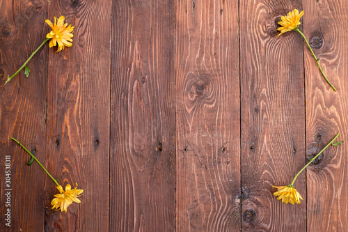 Wooden background with flowers for a frame.
