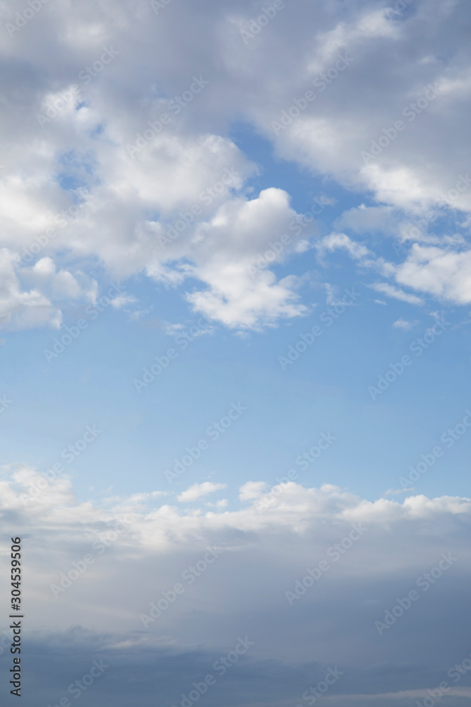 Clear blue sky between clouds in the bottom and top of image Clear blue sky between clouds in the bottom and top of image