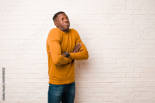 Quadro su tela young african american black man shrugging, feeling confused and uncertain, doub