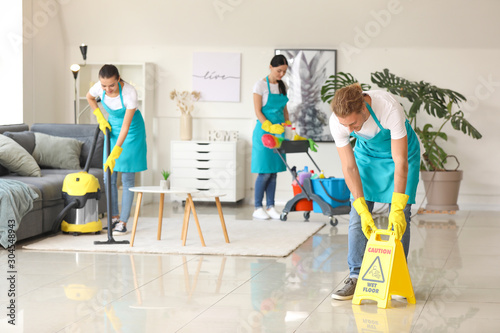 Team of janitors cleaning flat