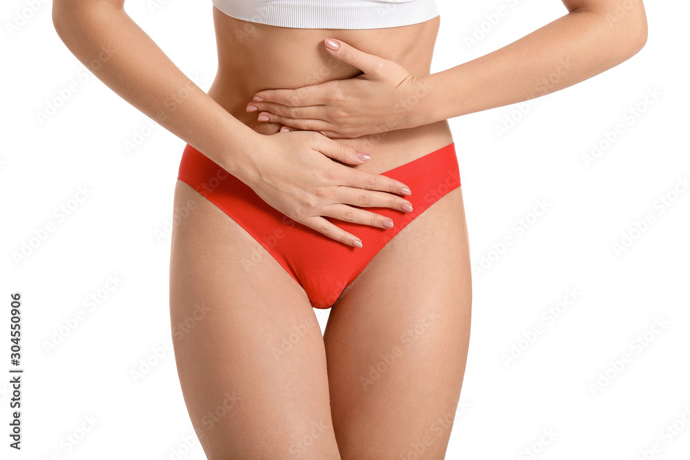 Young woman suffering from abdominal pain on white background. Gynecology concept Young woman suffering from abdominal pain on white background. Gynecology concept