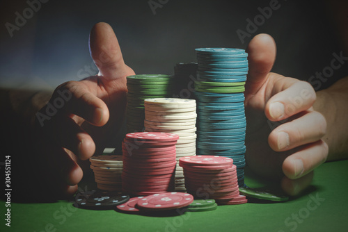 Male hands and poker chips close up. Prize of the winner or all in concept.