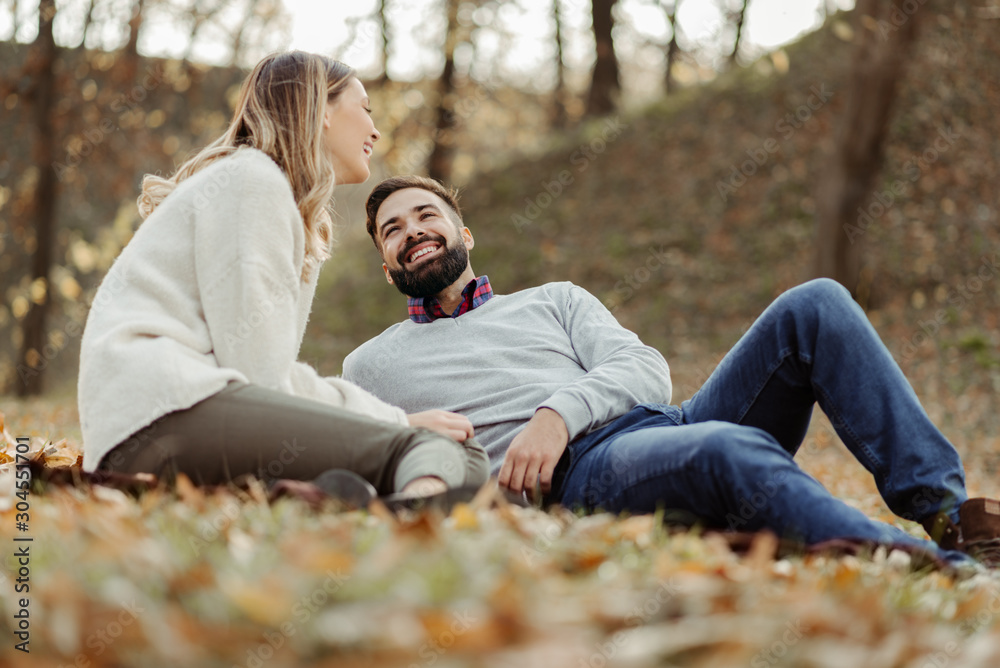 Young happy couple enjoying in autumn day and talking to each other Young happy couple enjoying in autumn day and talking to each other