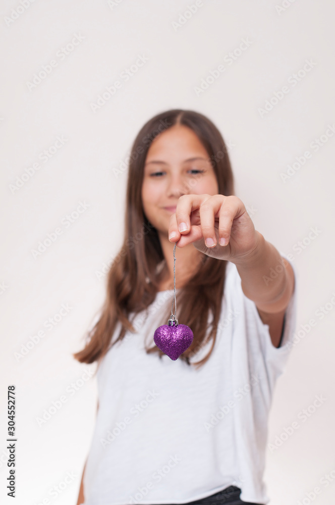 Young girl is holding heart in her hands Young girl is holding heart in her hands
