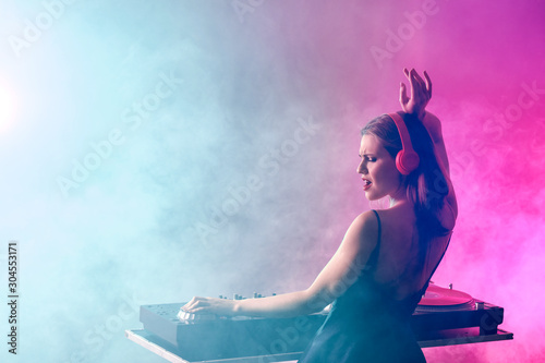 Female dj playing music in ...