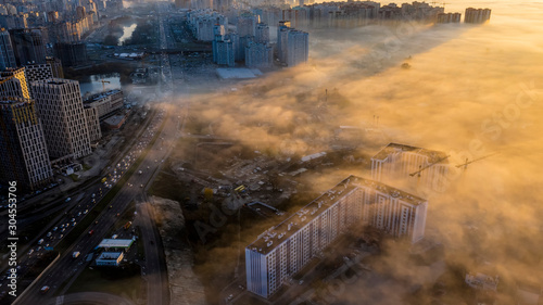 High-rise buildings in the morning autumn fog