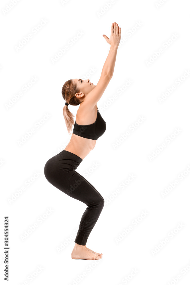 Beautiful young woman practicing yoga on white background