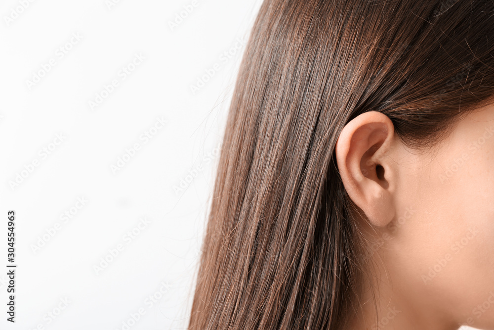 Young woman with hearing problem on white background Young woman with hearing problem on white background