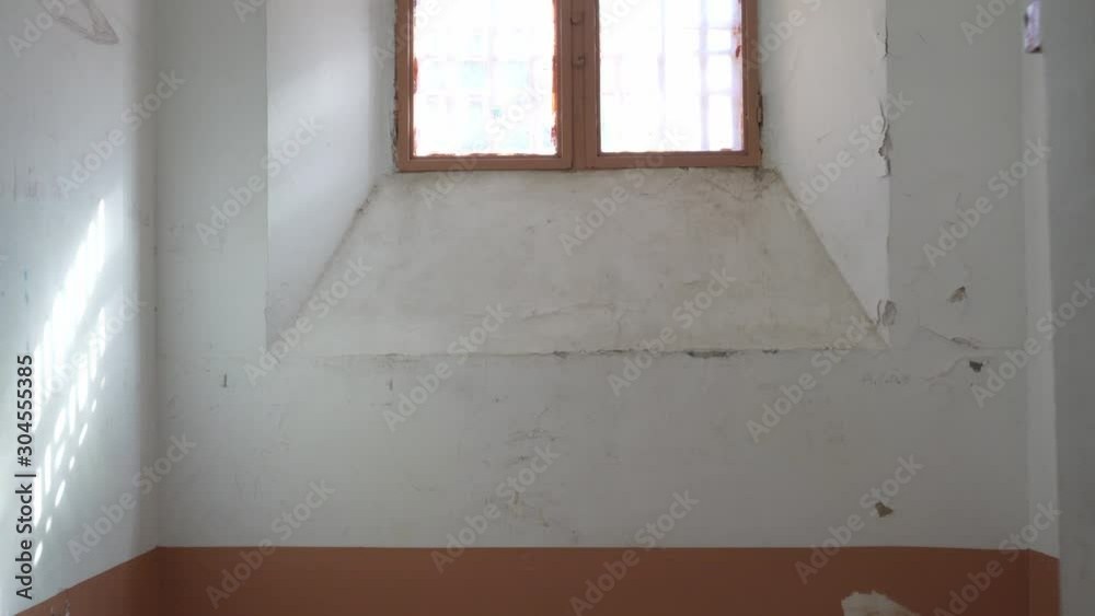 entrance to the prison cell towards the window with metal bars entrance to the prison cell towards the window with metal bars