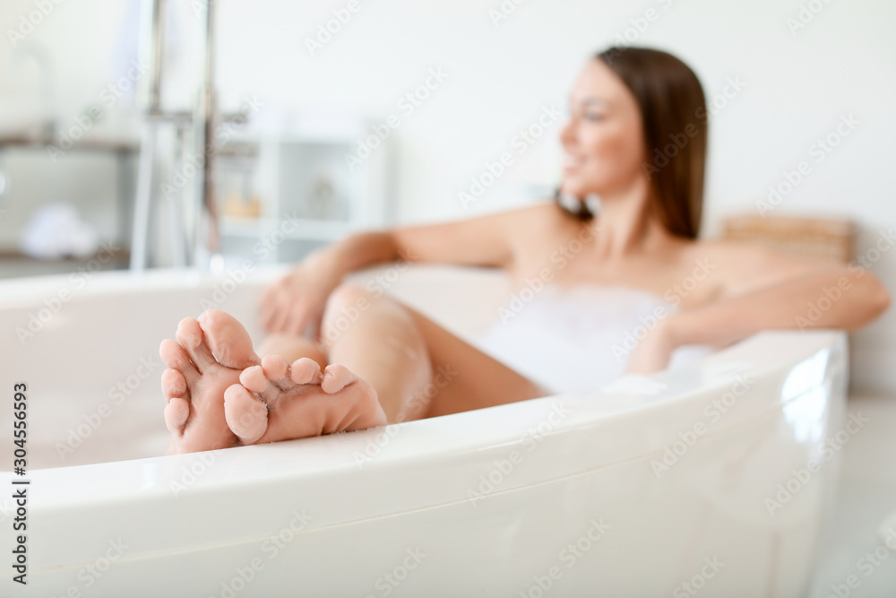 Beautiful young woman relaxing in bathtub Stock Photo