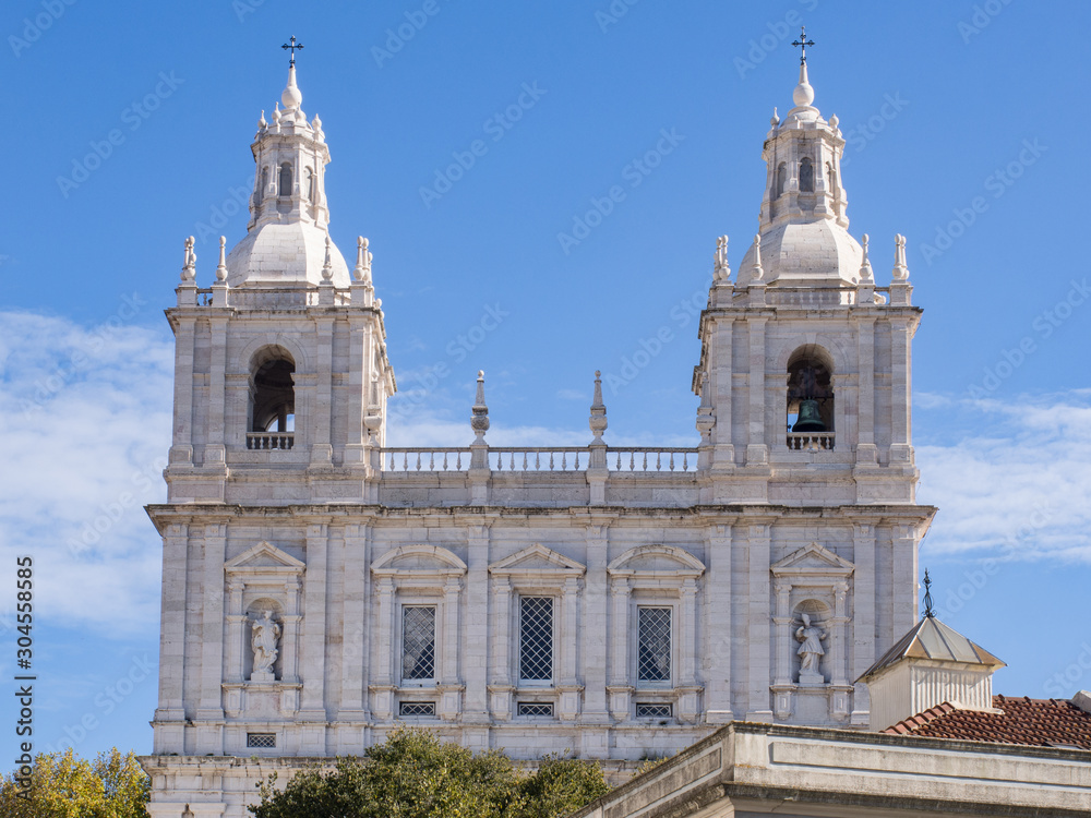 Church with two bell towers against a blue sky in Lisbon