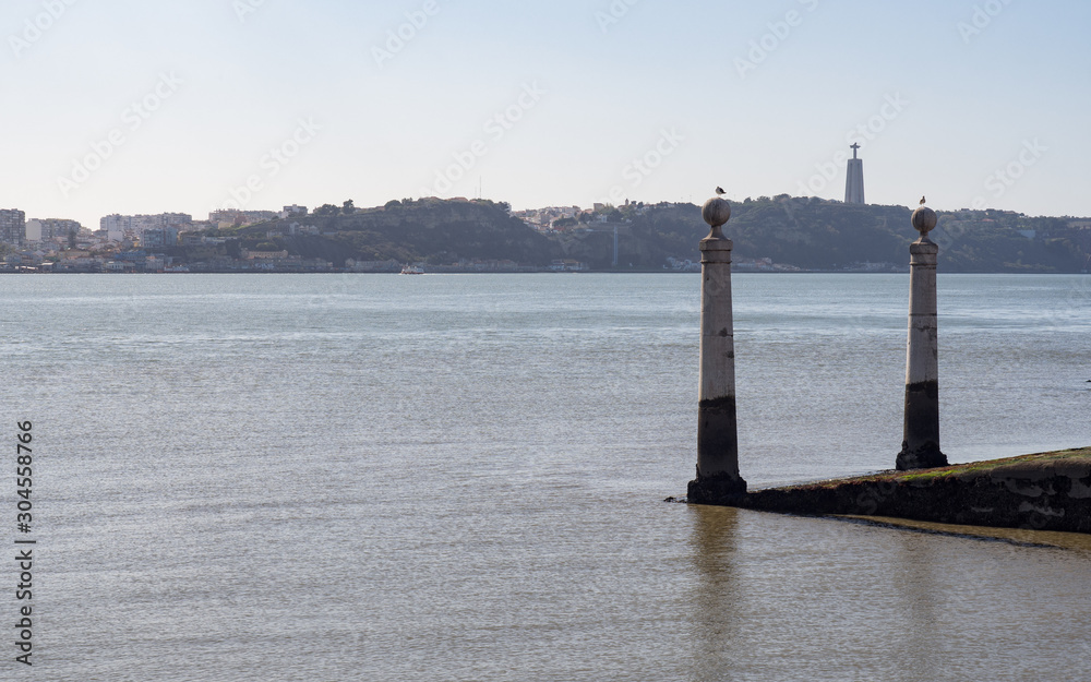 Coastal landscape with two posts and seagulls on them in Lisbon